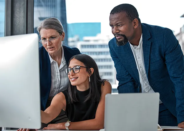 Marketo implementation consulting | team gathered around computer